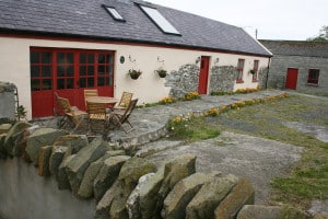 reclaimed stone used to build wall around this cottage - which also has some original stone work